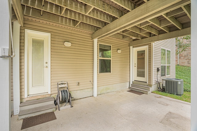 entrance to property with a patio and central air condition unit