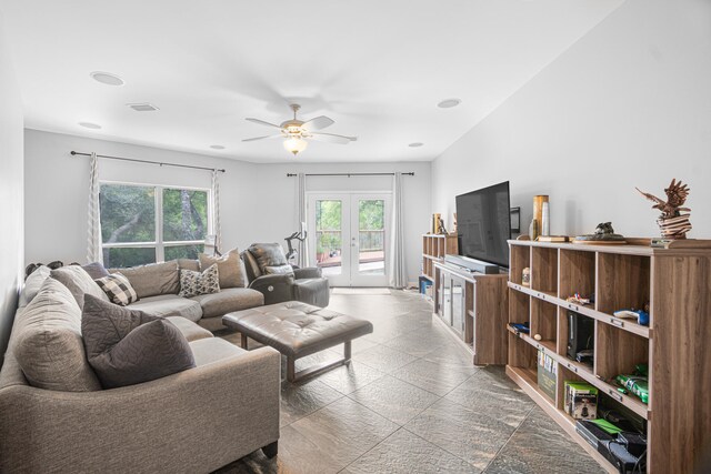 living room featuring ceiling fan and french doors