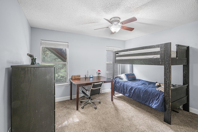 bedroom featuring a textured ceiling, ceiling fan, and carpet flooring