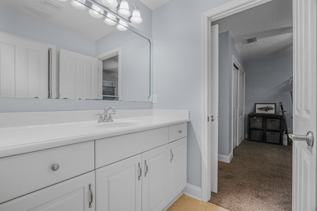 bathroom featuring vanity and a textured ceiling