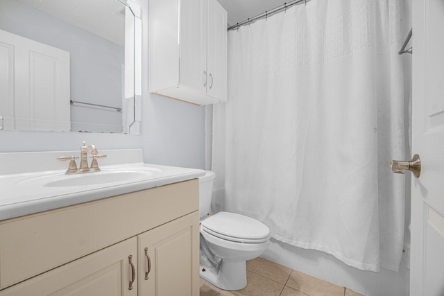 bathroom with tile patterned floors, toilet, curtained shower, and vanity