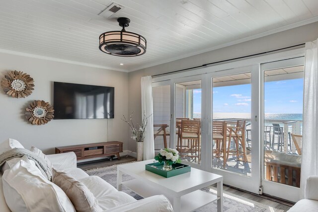 living room featuring crown molding and hardwood / wood-style floors