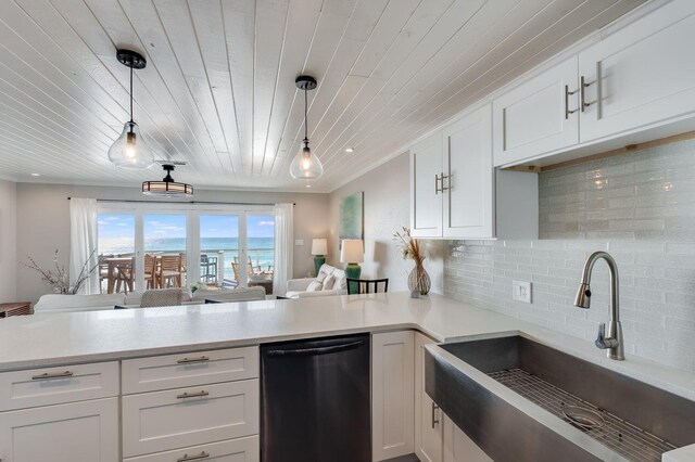 kitchen with pendant lighting, white cabinets, dishwasher, and sink