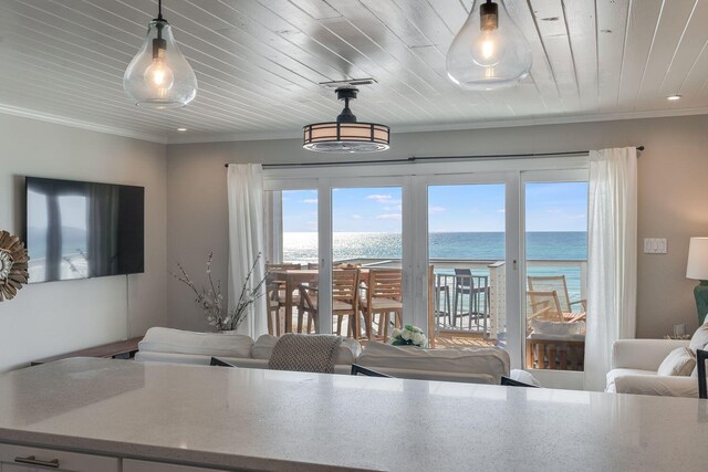 dining space featuring ornamental molding, wooden ceiling, a water view, and plenty of natural light