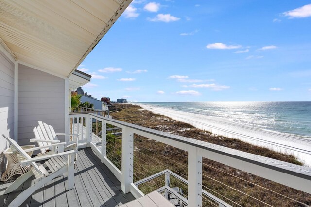 balcony featuring a beach view and a water view