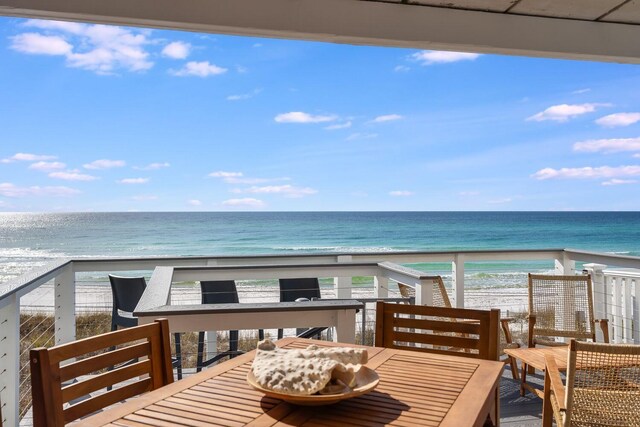 exterior space featuring a water view and a view of the beach