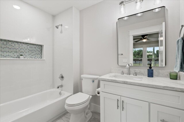 full bathroom featuring ceiling fan, toilet, shower / bath combination, and vanity