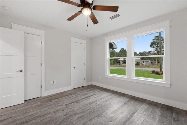 unfurnished bedroom with multiple windows, light hardwood / wood-style flooring, and ceiling fan