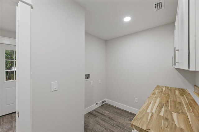 laundry room with cabinets, washer hookup, and dark wood-type flooring