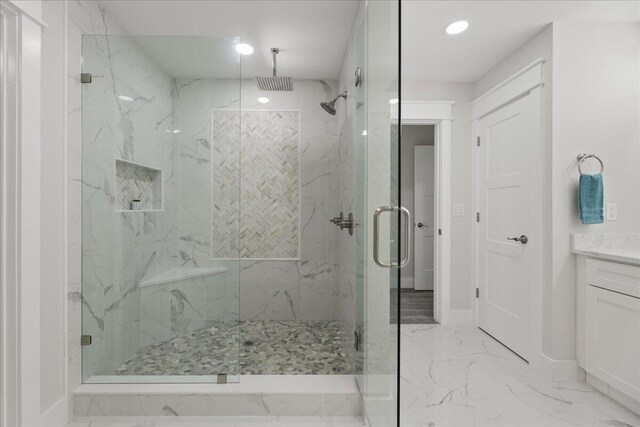 bathroom featuring vanity and a shower with door