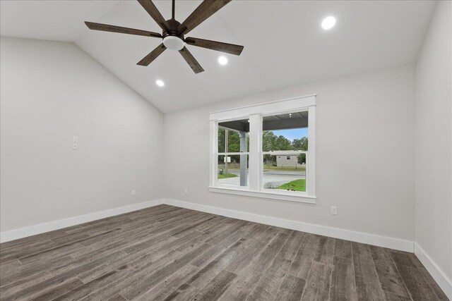 spare room featuring hardwood / wood-style floors, vaulted ceiling, and ceiling fan