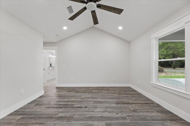 unfurnished room with ceiling fan, dark hardwood / wood-style flooring, and lofted ceiling