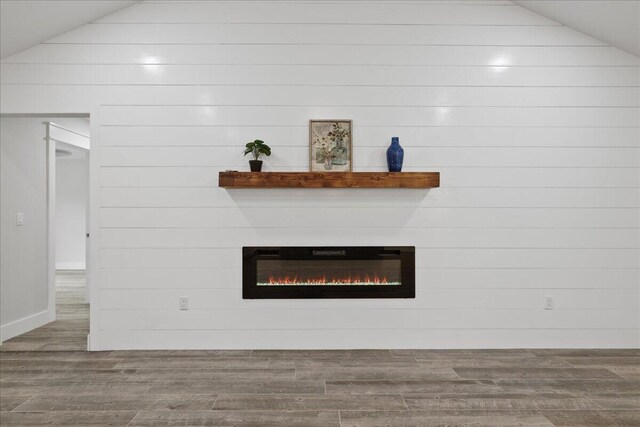 details with wood-type flooring and wooden walls