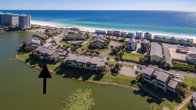 birds eye view of property featuring a beach view and a water view