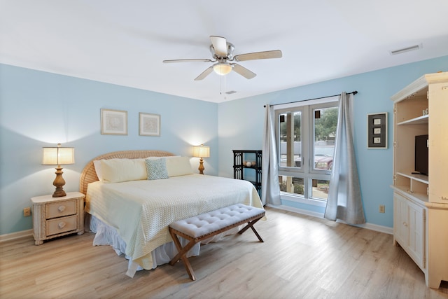 bedroom with light hardwood / wood-style floors and ceiling fan