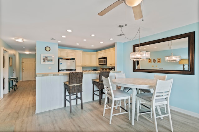 dining room featuring ceiling fan and light wood-type flooring