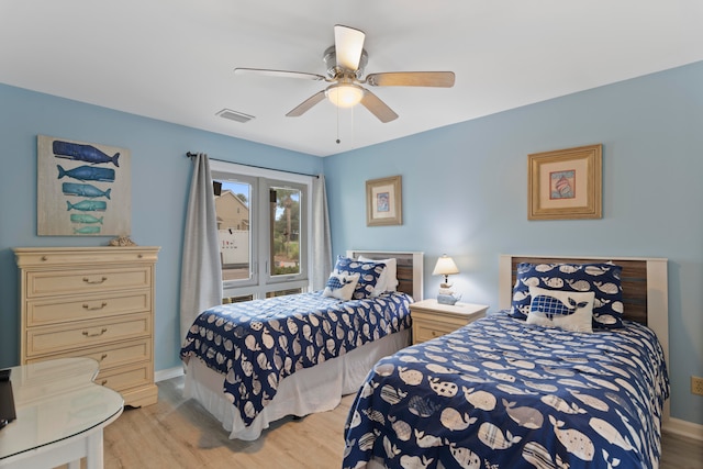 bedroom with light hardwood / wood-style floors and ceiling fan