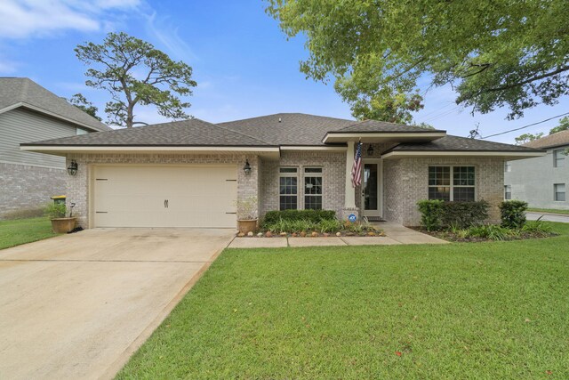 prairie-style house featuring a garage and a front yard