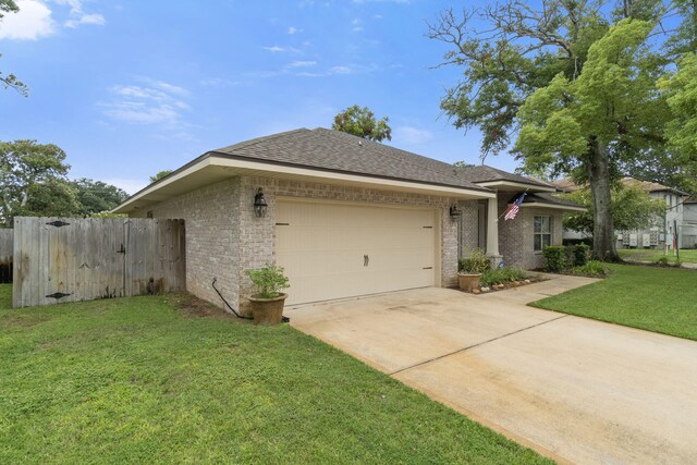 view of front of property featuring a garage and a front yard