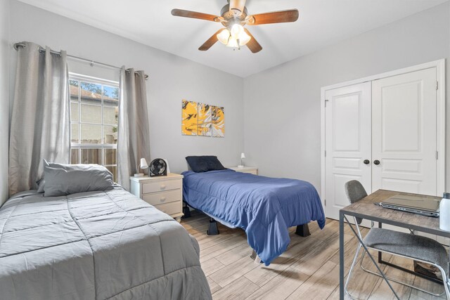 bedroom with a closet, ceiling fan, and light hardwood / wood-style floors