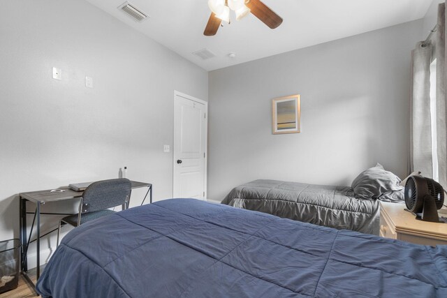 bedroom with lofted ceiling, ceiling fan, and hardwood / wood-style floors