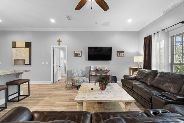 living room featuring crown molding, light hardwood / wood-style flooring, and ceiling fan