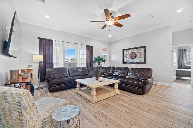 living room featuring ceiling fan, light hardwood / wood-style floors, and crown molding