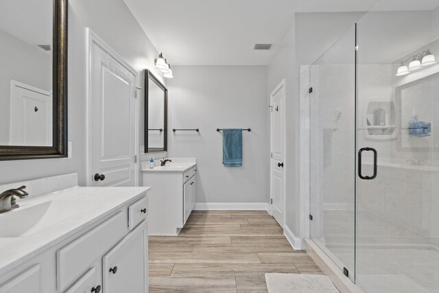 bathroom featuring vanity, hardwood / wood-style flooring, and walk in shower