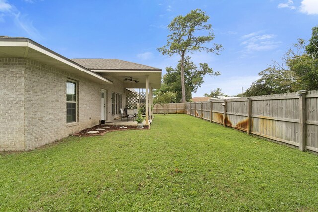 view of yard with ceiling fan and a patio area