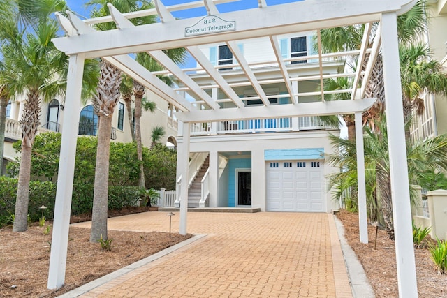 view of front of house featuring a garage and a pergola