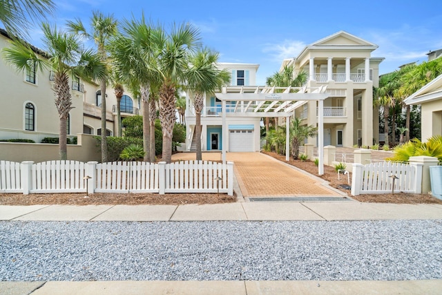 view of front of house featuring a garage and a balcony