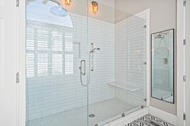 bathroom with tile patterned flooring and a shower with shower door