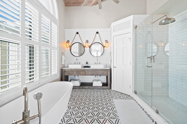 bathroom featuring vanity and independent shower and bath