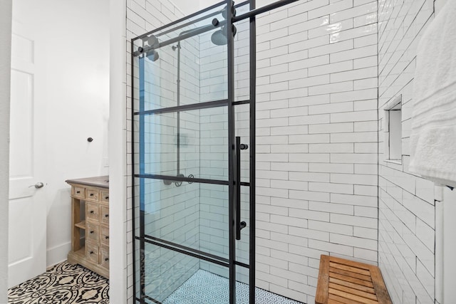 bathroom with vanity and a shower with shower door