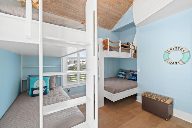 bedroom with wood ceiling, lofted ceiling, and hardwood / wood-style floors