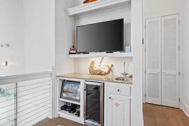 bar featuring backsplash, white cabinetry, sink, dark hardwood / wood-style floors, and beverage cooler