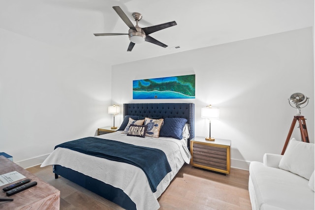 bedroom with hardwood / wood-style floors and ceiling fan