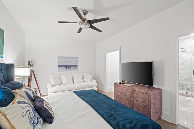 bedroom with ensuite bath, ceiling fan, and light hardwood / wood-style floors