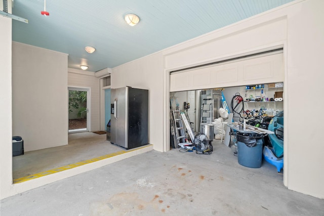 garage with stainless steel refrigerator with ice dispenser