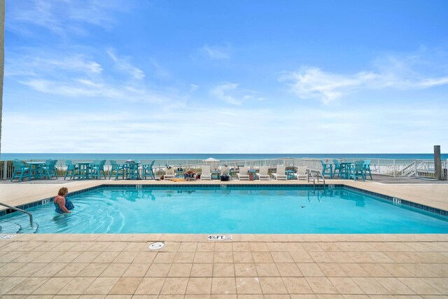 view of swimming pool with a water view