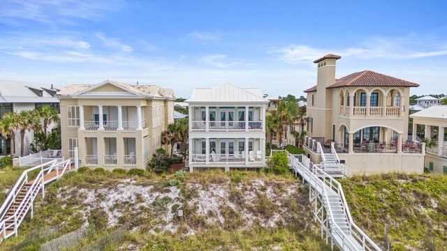 back of house featuring a balcony