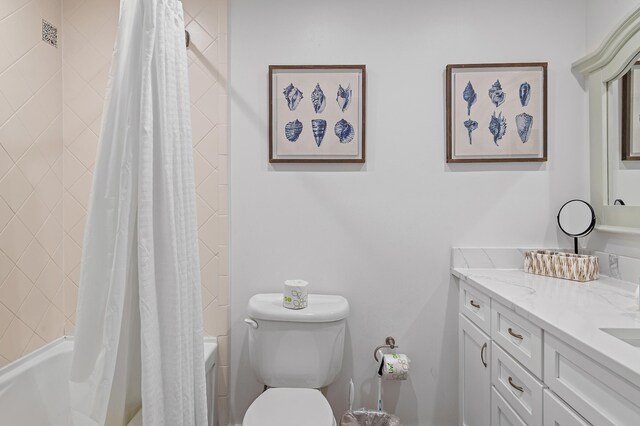 full bathroom with shower / bath combo, vanity, and toilet