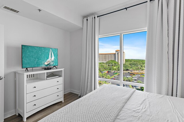 bedroom with dark hardwood / wood-style flooring