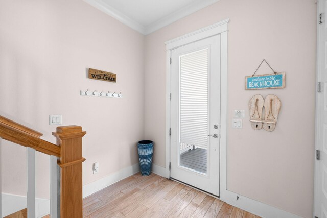 doorway to outside featuring light hardwood / wood-style flooring and ornamental molding