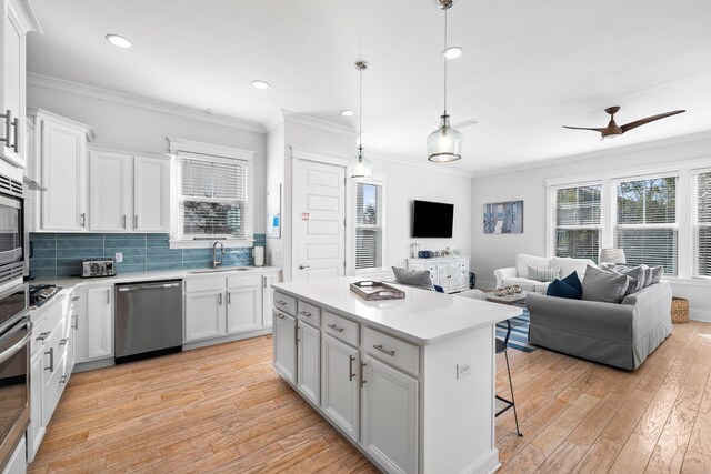 kitchen featuring light hardwood / wood-style flooring, white cabinets, appliances with stainless steel finishes, and sink