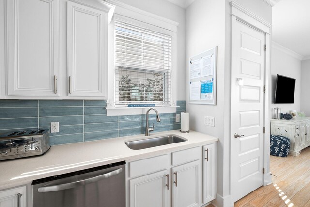 kitchen with white cabinets, dishwasher, and sink