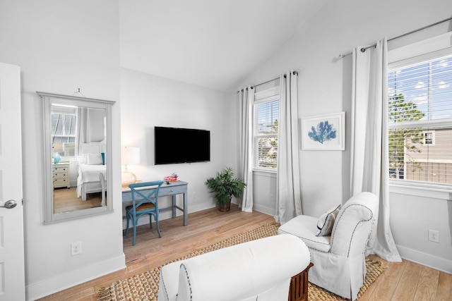 living room with vaulted ceiling and hardwood / wood-style floors