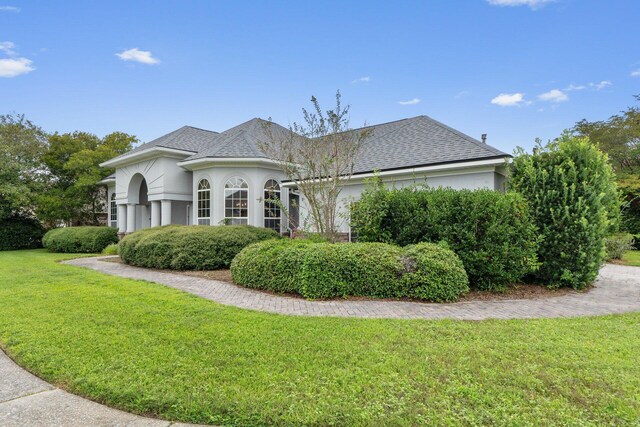 view of side of home with a lawn