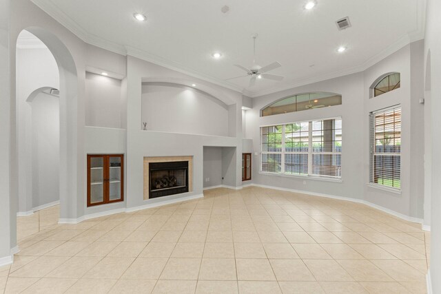 unfurnished living room with ornamental molding, light tile patterned floors, and ceiling fan