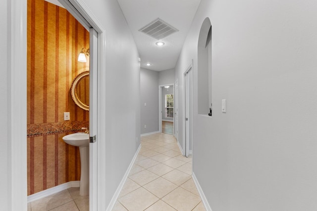 hall with light tile patterned floors